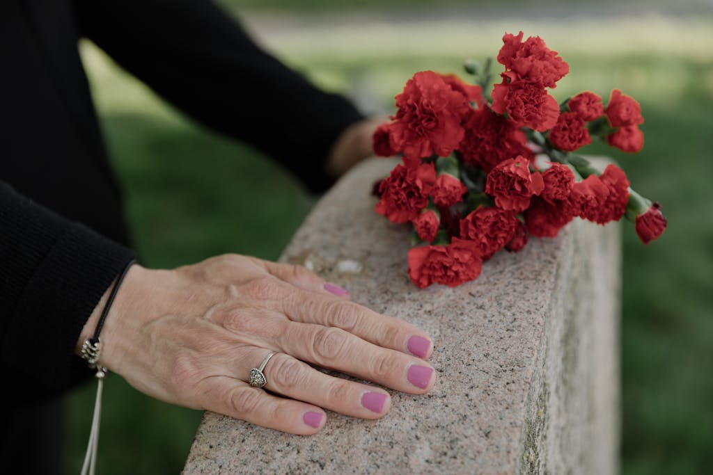 Person Touching a Headstone
